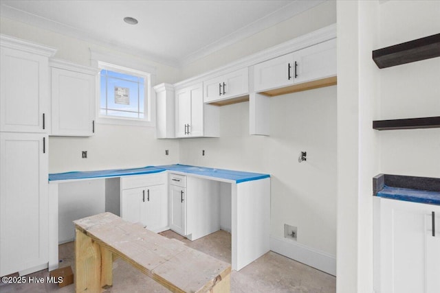 kitchen featuring crown molding and white cabinets