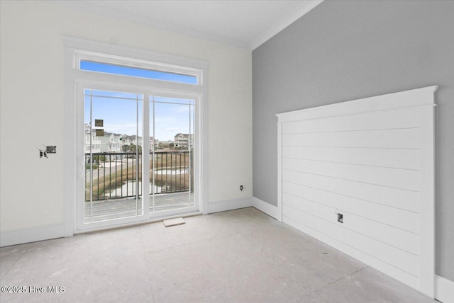 empty room with crown molding and a water view