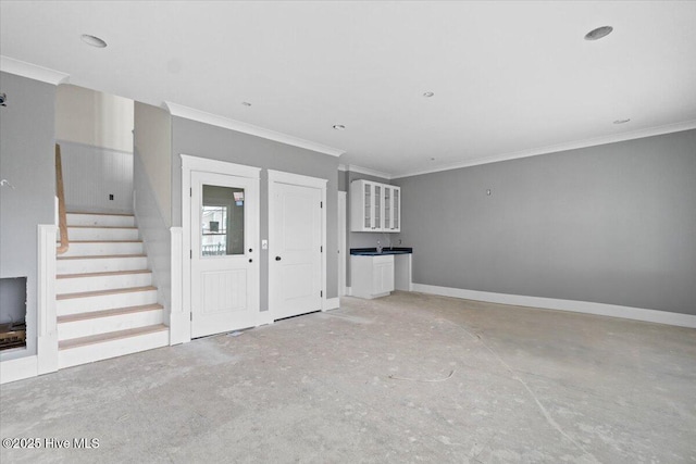 unfurnished living room with ornamental molding