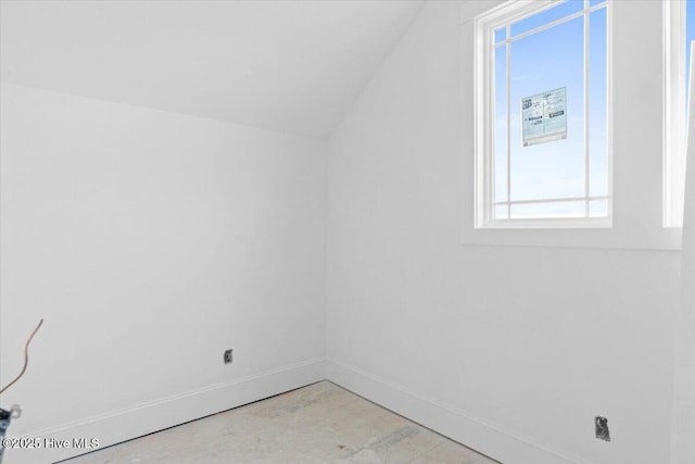 spare room with vaulted ceiling