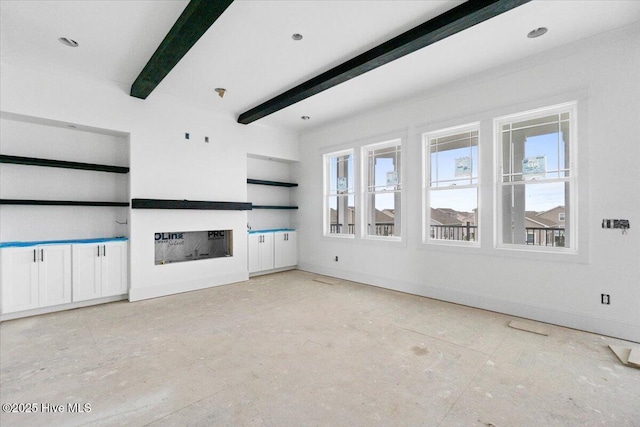 unfurnished living room with beamed ceiling