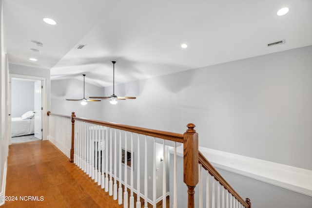 hallway featuring vaulted ceiling and hardwood / wood-style floors