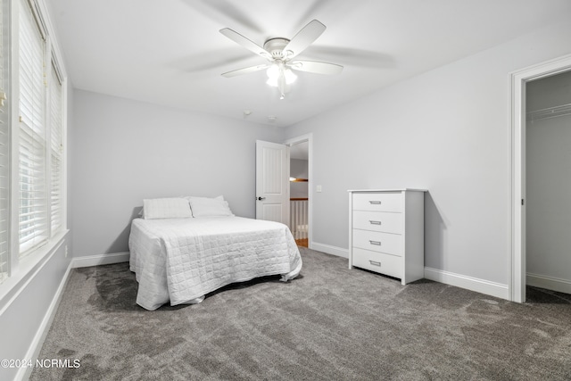 carpeted bedroom featuring ceiling fan and a closet