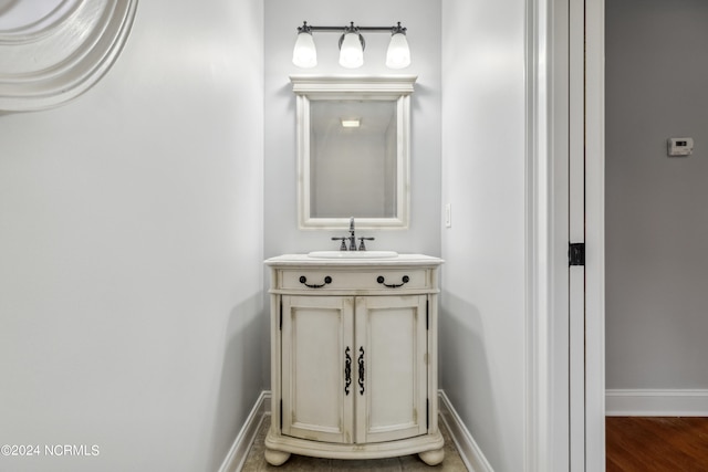 bathroom featuring hardwood / wood-style flooring and vanity