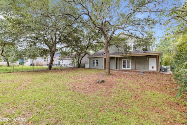 exterior space featuring central AC and a front lawn