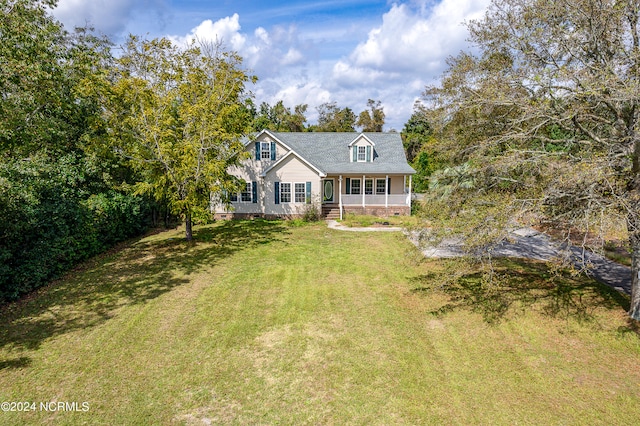 cape cod home with covered porch and a front yard