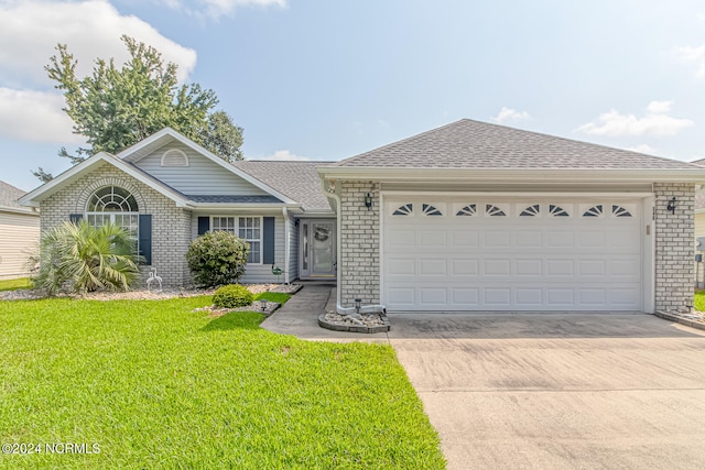 single story home featuring a front lawn and a garage