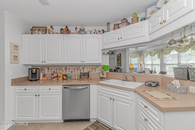 kitchen with dishwasher, light countertops, a sink, and white cabinetry