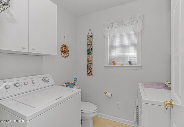 clothes washing area with light tile patterned floors