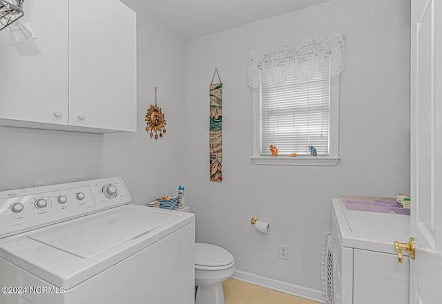 clothes washing area featuring laundry area, washer and clothes dryer, and baseboards