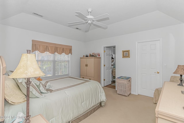 carpeted bedroom with a tray ceiling, ceiling fan, and vaulted ceiling