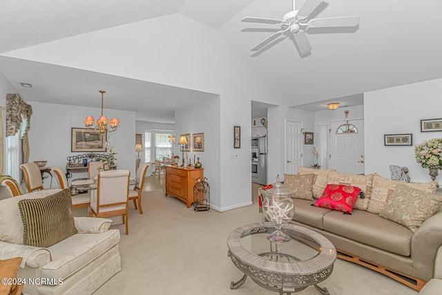 living room featuring light carpet, baseboards, high vaulted ceiling, and ceiling fan with notable chandelier