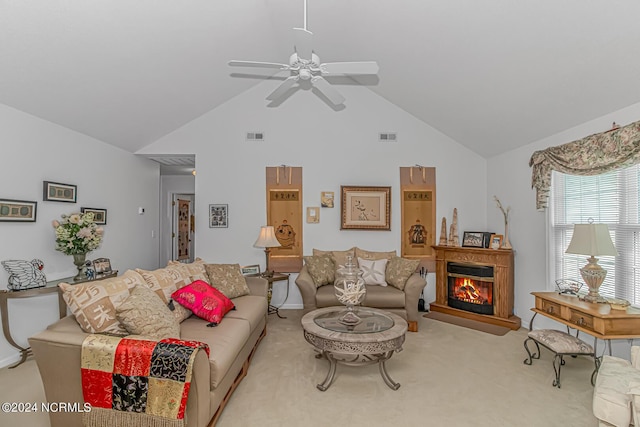 carpeted living area featuring a ceiling fan, a glass covered fireplace, visible vents, and high vaulted ceiling