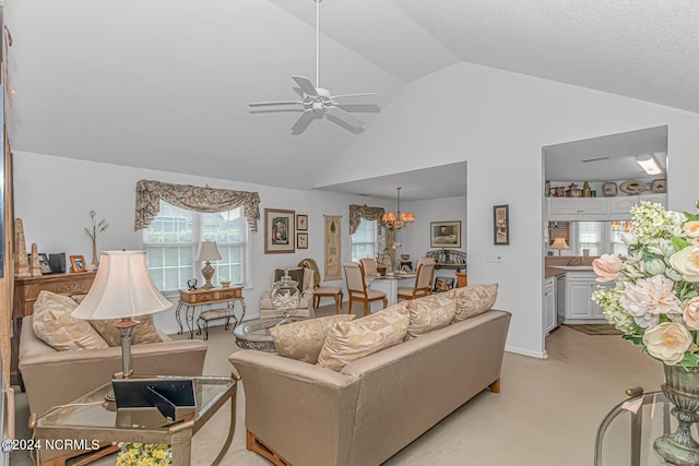 living room with high vaulted ceiling, light colored carpet, and ceiling fan with notable chandelier