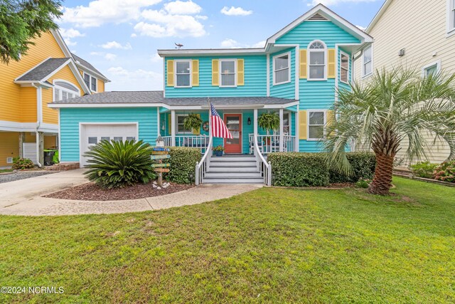 view of front of home with a porch, a garage, and a front yard