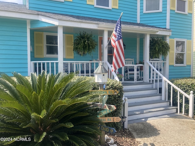 142 Carolina Ave, Holden Beach, NC 28462 - property entrance featuring covered porch and a shingled roof