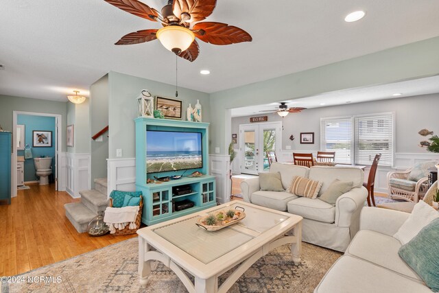 142 Carolina Ave, Holden Beach, NC 28462 - living room with ceiling fan, a decorative wall, a wainscoted wall, stairs, and recessed lighting