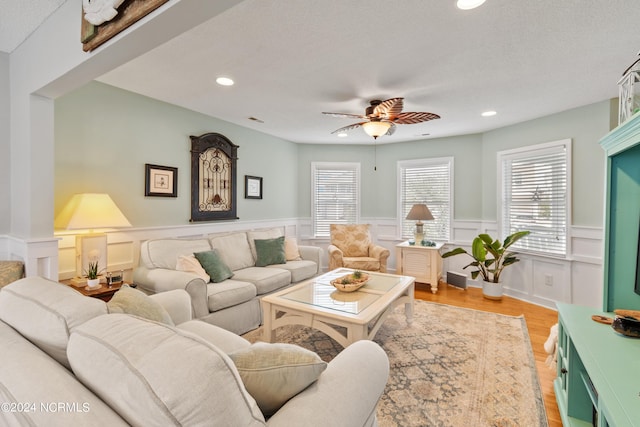 142 Carolina Ave, Holden Beach, NC 28462 - living room featuring a ceiling fan, recessed lighting, wainscoting, light wood-style floors, and a decorative wall