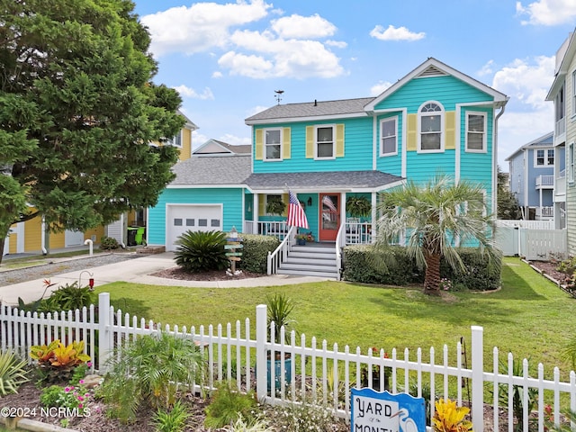 view of front of house featuring a fenced front yard, a porch, an attached garage, driveway, and a front lawn