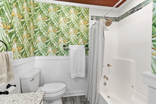 full bathroom with a wainscoted wall, toilet, shower / tub combo, wood finished floors, and wallpapered walls