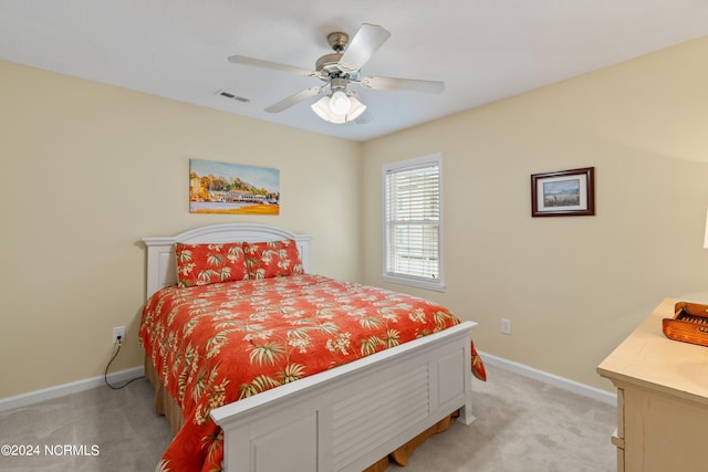 bedroom featuring light colored carpet, visible vents, ceiling fan, and baseboards