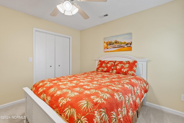 bedroom with carpet floors, a closet, visible vents, ceiling fan, and baseboards