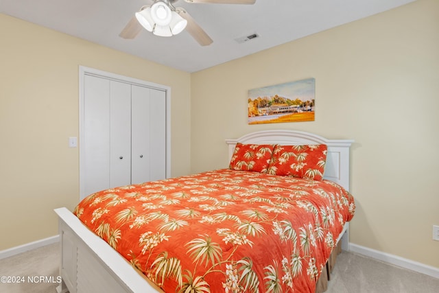 142 Carolina Ave, Holden Beach, NC 28462 - bedroom with carpet, baseboards, a closet, and a ceiling fan