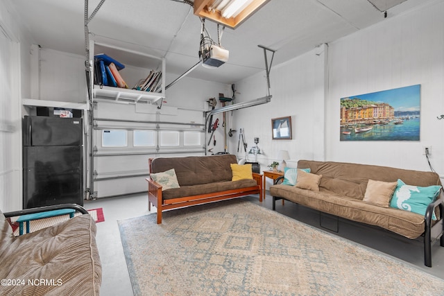 garage with freestanding refrigerator and a garage door opener