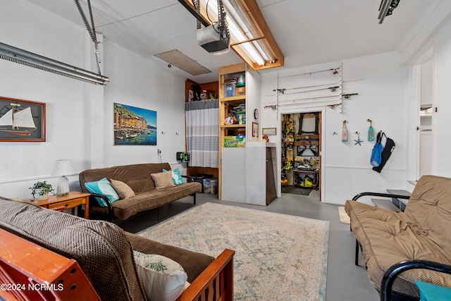 living room with a garage and finished concrete floors