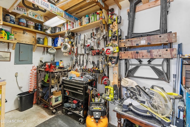 storage area featuring a garage and electric panel