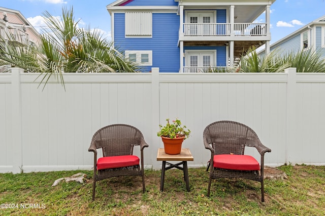 142 Carolina Ave, Holden Beach, NC 28462 - view of patio / terrace with a balcony, a fenced backyard, and french doors