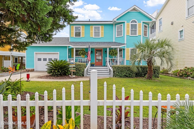 view of front of house with a fenced front yard, a garage, covered porch, driveway, and a front yard