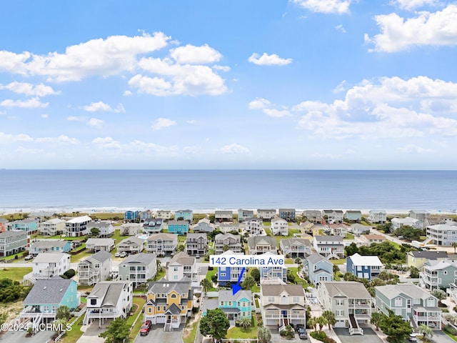 drone / aerial view with a residential view and a water view