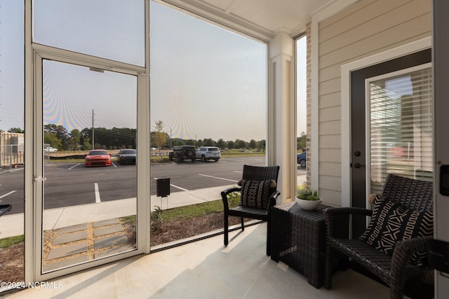 sunroom / solarium featuring a healthy amount of sunlight and french doors