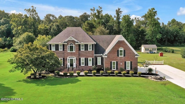 colonial home with a front lawn