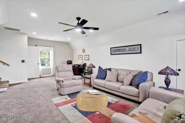 living room featuring carpet flooring, ceiling fan, and vaulted ceiling