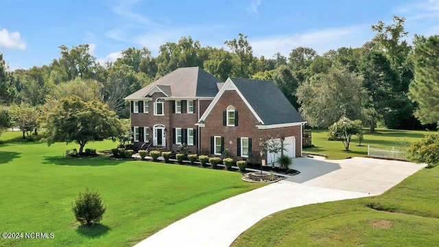 view of front of property featuring a front yard and a garage