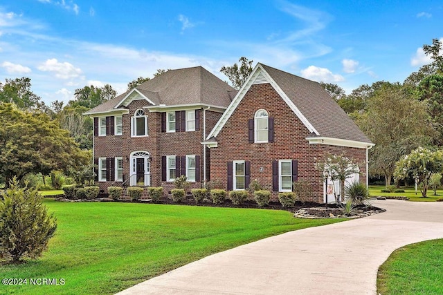 colonial home with a front lawn