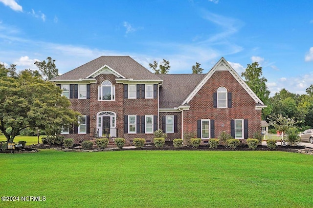 colonial-style house with a front yard