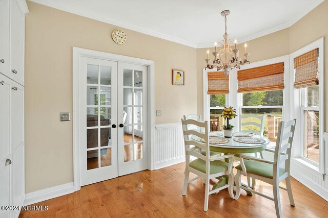 doorway featuring a wealth of natural light, french doors, a towering ceiling, and light wood-type flooring