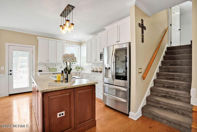 dining space featuring a chandelier, french doors, and wood-type flooring