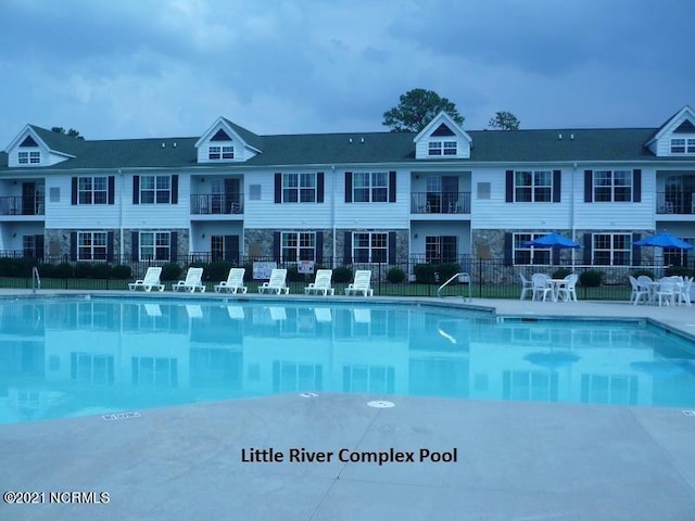 view of pool featuring fence