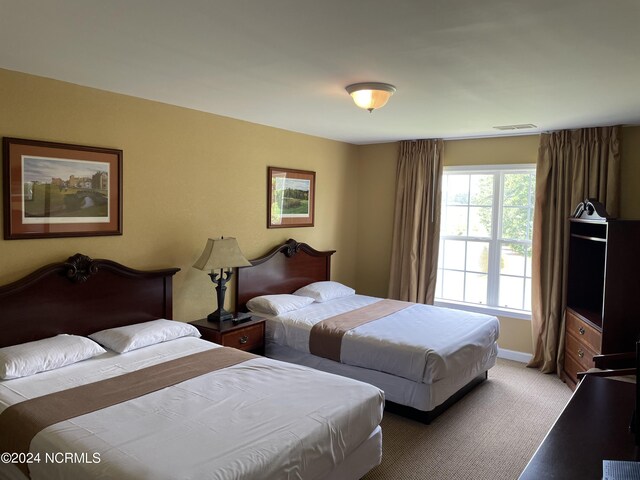 bedroom featuring light colored carpet