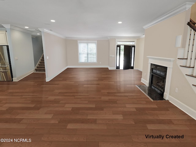 unfurnished living room with ornamental molding, a high end fireplace, and dark hardwood / wood-style floors