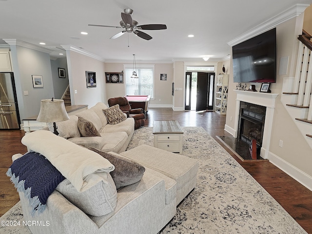 living room featuring ornamental molding, dark hardwood / wood-style flooring, and ceiling fan