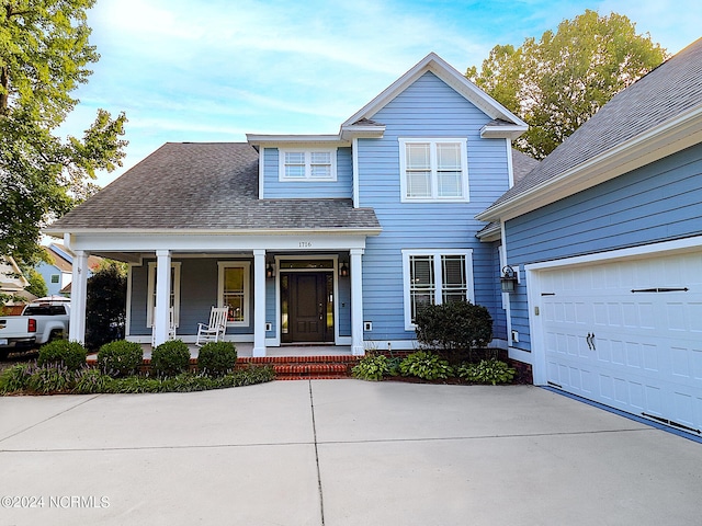 view of front of property featuring a garage and covered porch