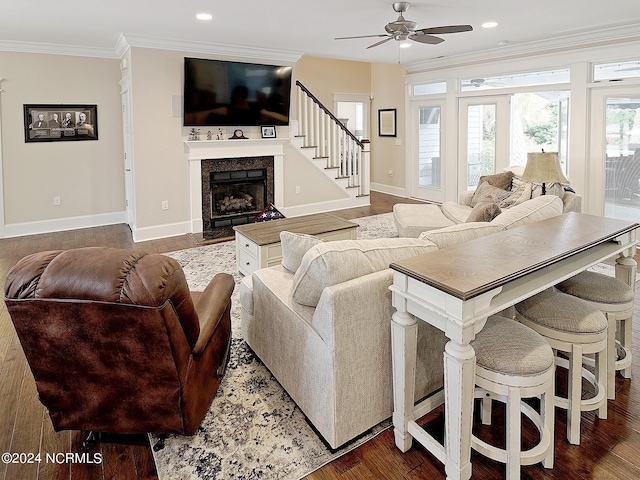 living room featuring ornamental molding, ceiling fan, and dark hardwood / wood-style flooring