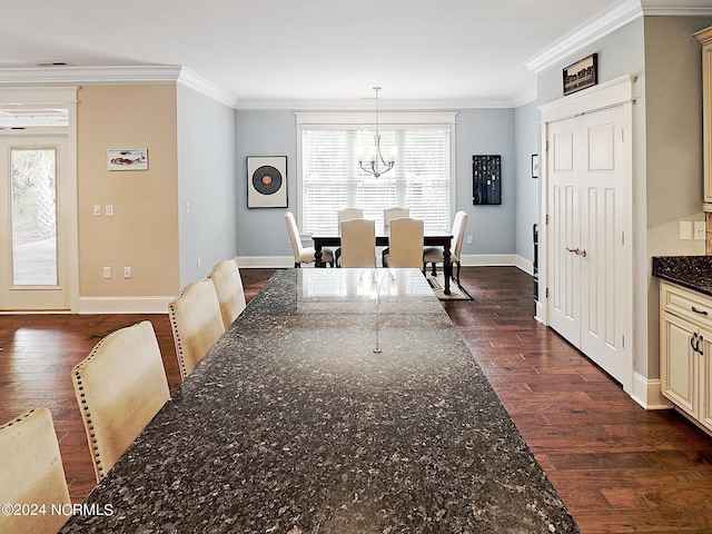 dining room with crown molding, dark wood-type flooring, and a chandelier