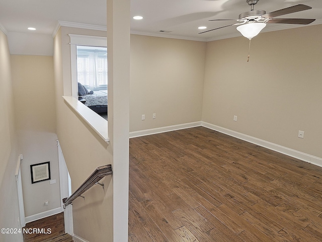 unfurnished room with crown molding, dark hardwood / wood-style floors, and ceiling fan