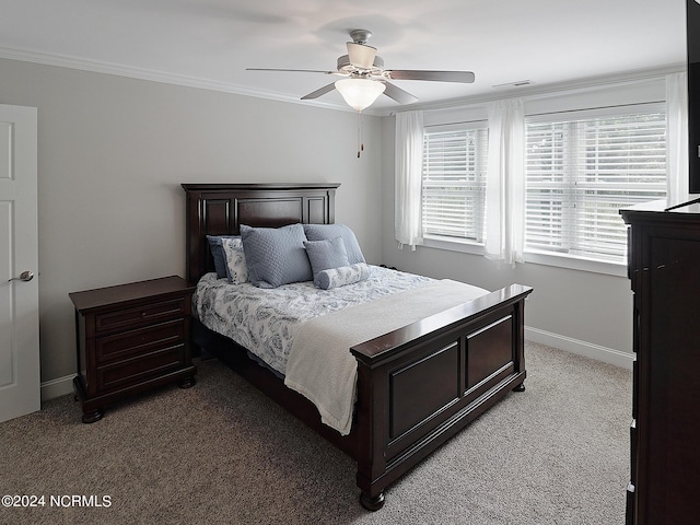 carpeted bedroom with ornamental molding and ceiling fan